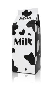 A milk carton with cow pattern over white background