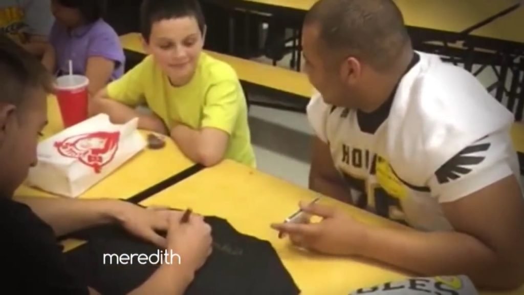 Brevin and Chris sitting with a bullied child. Image via YouTube. 