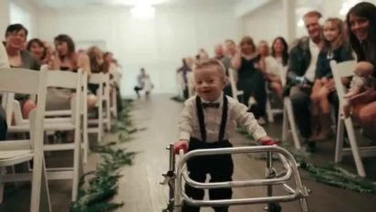 baby aisle surprise 412x232.jpg?resize=412,232 - Young Ring Bearer With Down Syndrome Proudly Walked Down The Aisle