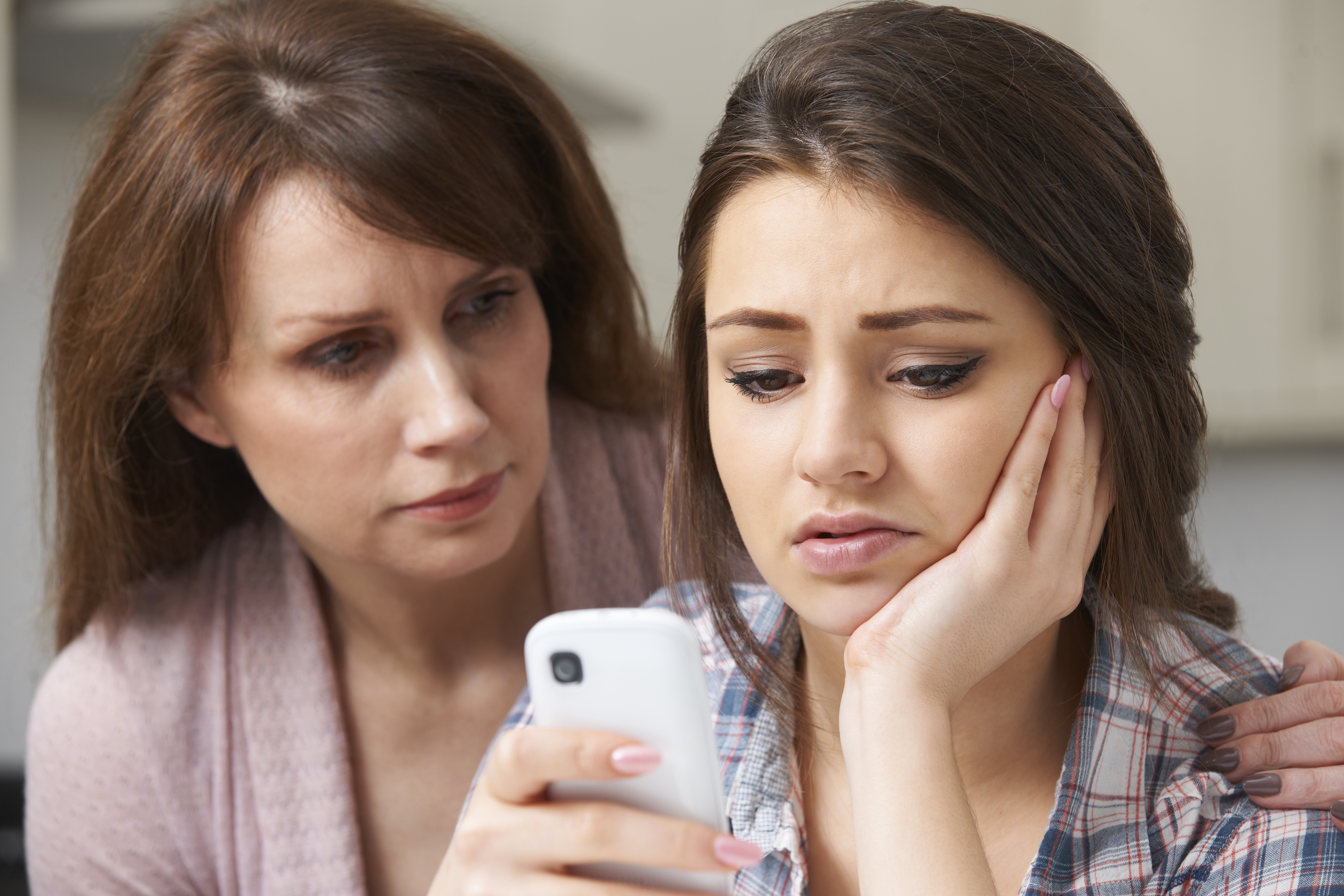 Mother Comforting Daughter Victimized By Text Bullying