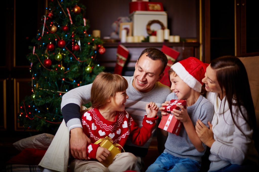 Joyful family having fun on Christmas evening at home