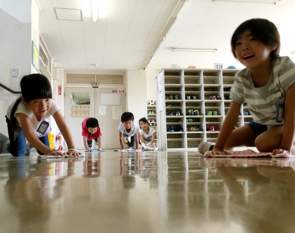 Tokyo, Japan - September 2 - 2016: Elementary school students are cleaning their classroom and school. In Japan students do the cleaning in the mornings and and after lunch except the toilets and teachers room.