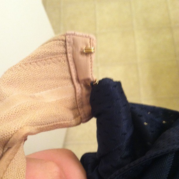 Unsolved Laundry Mysteries: How does a bra hook manage to snag a tiny hole in the mesh of my shorts and get so twisted up?