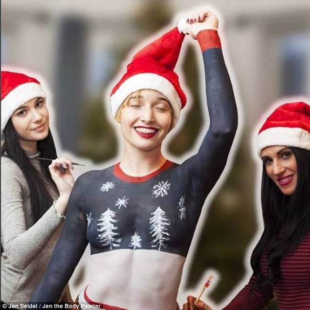 Holiday fun: Body painter Jen Seidel (right), gave model Lili (center) a body paint holiday makeover for her latest video