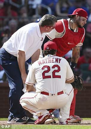 Catcher Yadier Molina grimaces in pain after a foul tip off a 102mph fastball struck him in the groin on Saturday in St. Louis