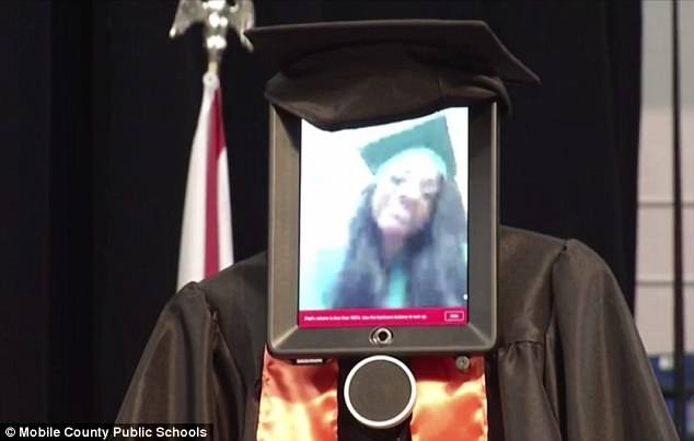 The robot and Pettway were both dressed in cap and gown for the graduation ceremony, Pettway pictured on iPad video stream