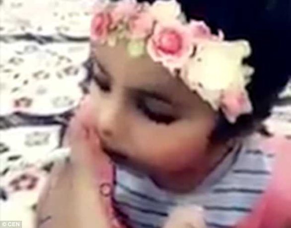 Shocking footage shows the father encouraging his child to take a drag on his cigarette