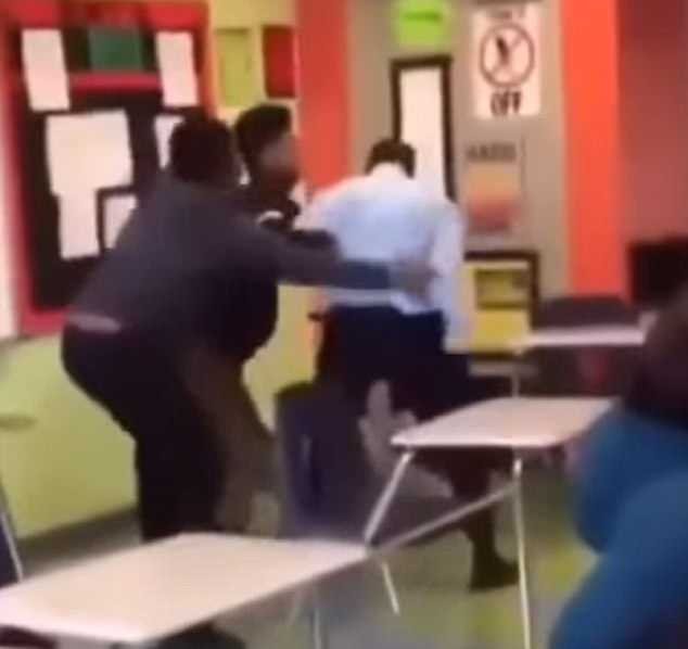 Students then intervened, two grabbing the teacher from behind to pull him awayÂ 