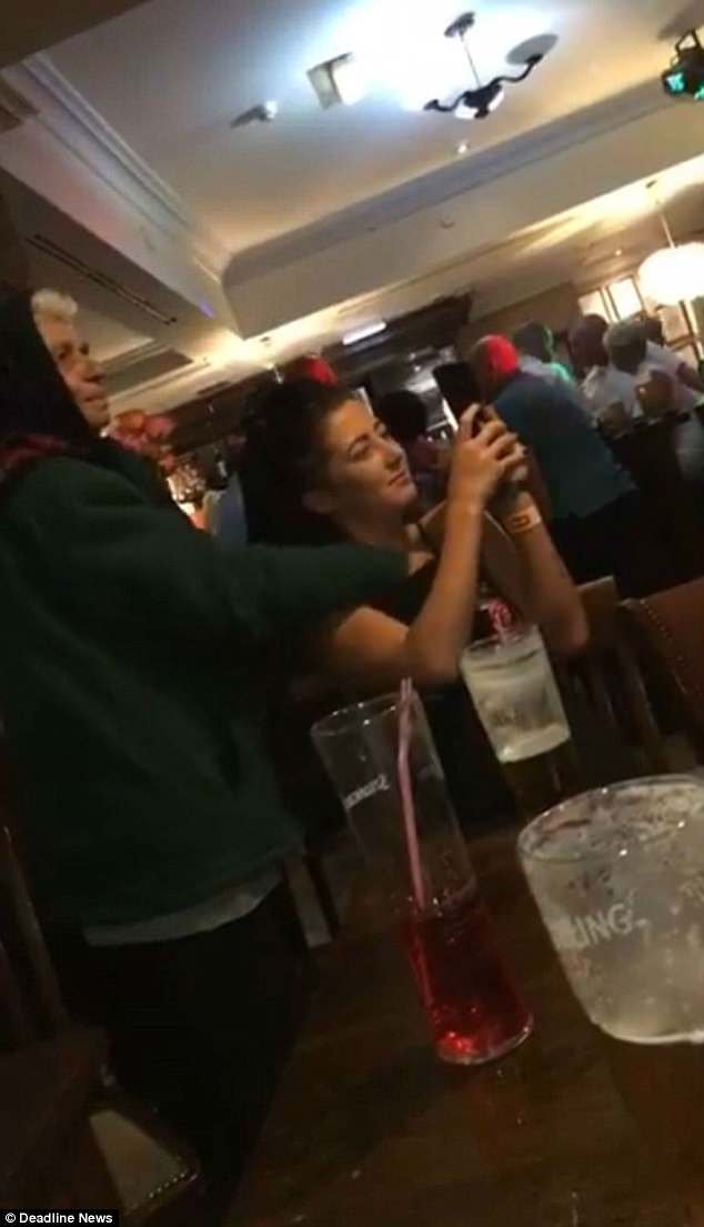 An elderly flower seller in a pub slips her hand down a woman