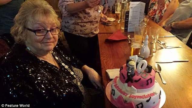 Happier times: Joy on her 70th birthday celebrating at a restaurant with some cake, not long before she moved to the care home