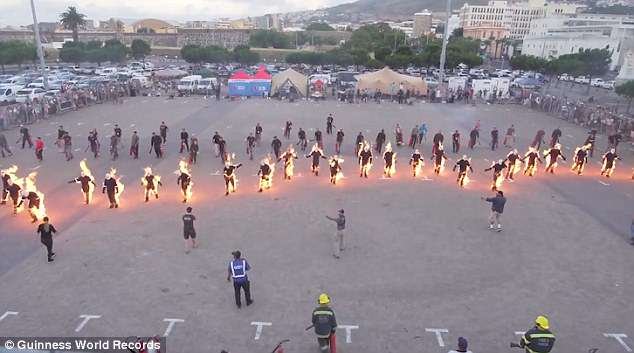 The 32 people that were set alight walked in unison across a car park to break the record