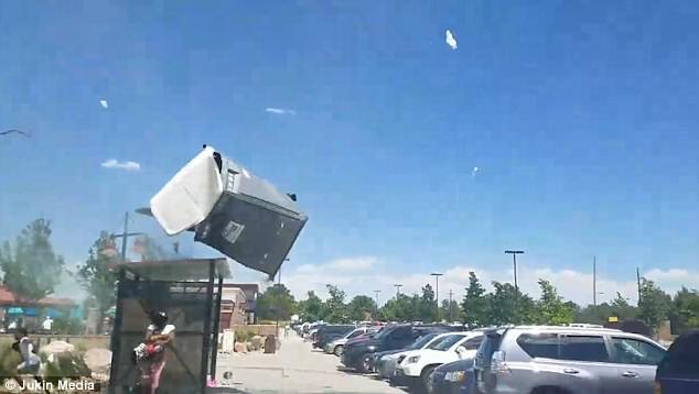 As they attempted to take cover by lying on the ground, the wind whisked two portable toilets straight into the air and flattened a nearby canopy tent