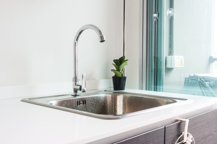 Water tap with sink in modern kitchen.
