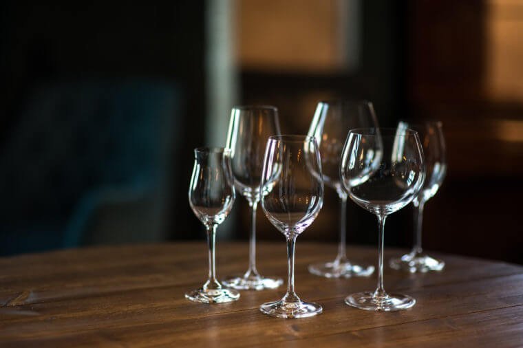 Different types of glasses for wine on wooden table. Still life concept.