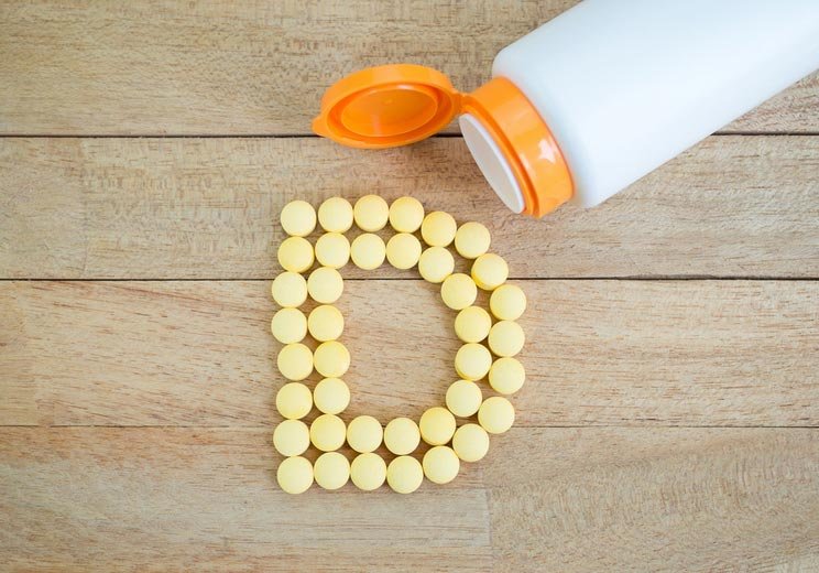 Yellow-Pills-Forming-Shape-To-D-Alphabet-On-Wood-Background.jpg