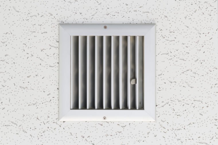 Grille of air conditioner system under ceiling.