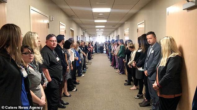 Dozens of staff lined the corridor and some appeared emotional as the terminally ill man was wheeled past in his final moments