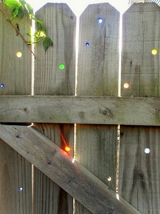 18 Upcycling Ideas - Have holes in your fence? Use marbles to plug them up.