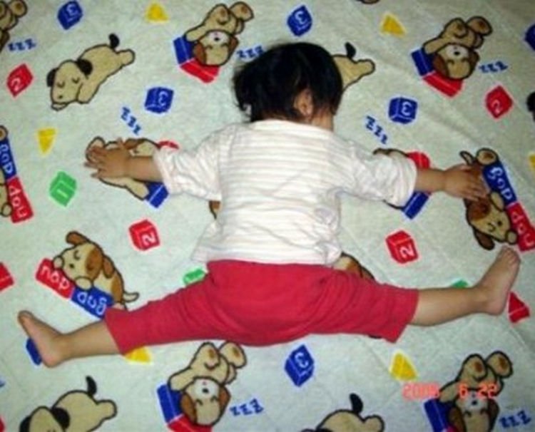 25 Kids Sleeping in the Strangest Places - She loves her bed "this much."
