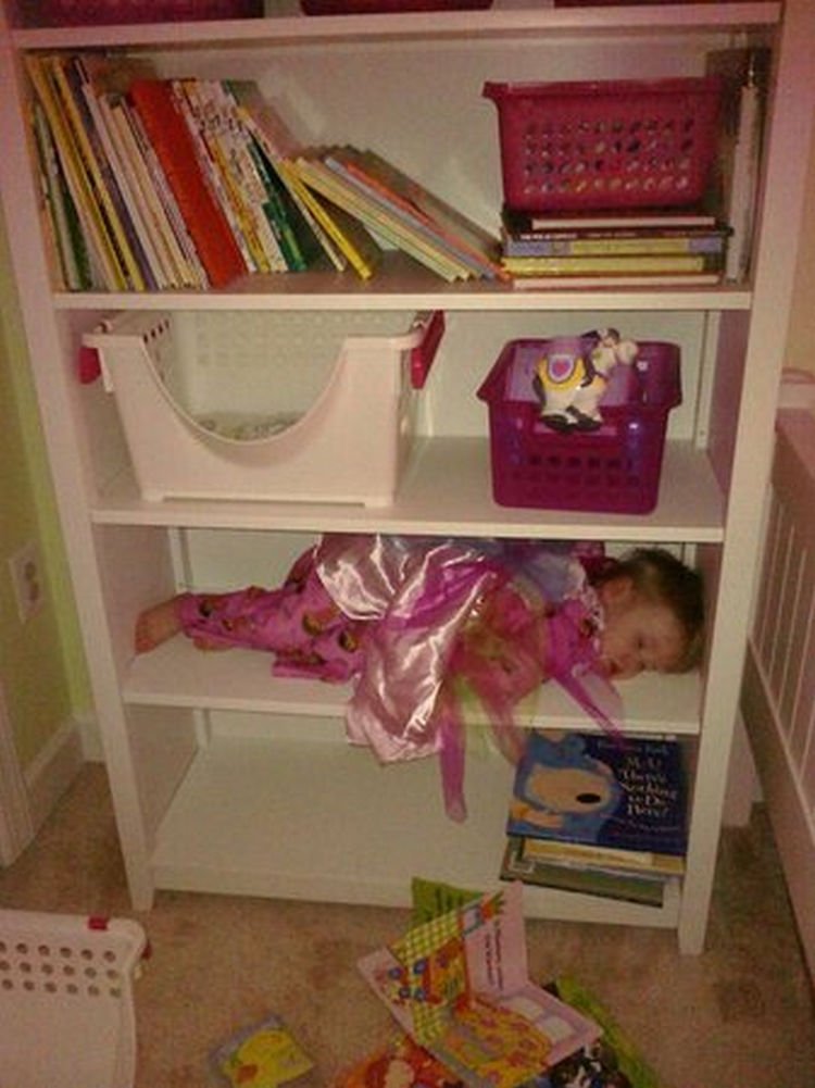 25 Kids Sleeping in the Strangest Places - This shelf is just her size.