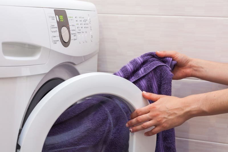 After about 15 minutes tumbling together, the towel will have soaked up a bunch of water from your clothes. Just take it out and hang it up to dry, and let the clothes finish drying faster than they would have otherwise. From here.