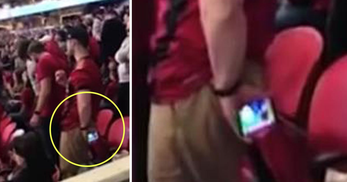 father holds mobile back.jpg?resize=1200,630 - Father Held Phone Behind His Back During Football Match To Let His Daughter Watch Cartoons