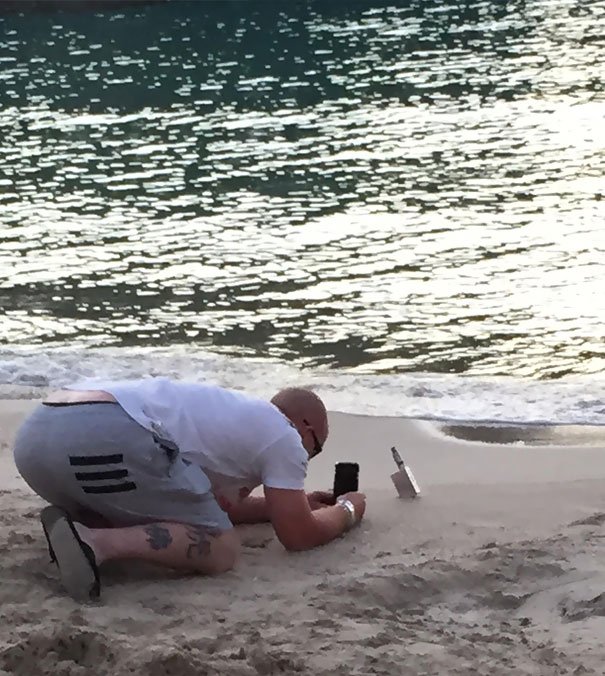 This Man Is Taking A Picture Of His Vape At The Beach
