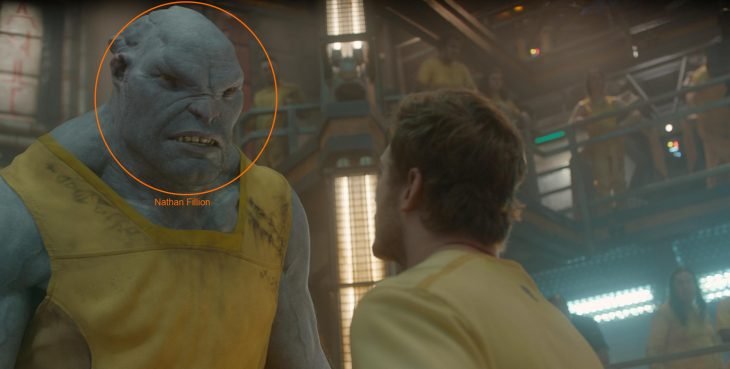 Hombre mirando a un extraterreste de colro azul a los ojos, escena de la película Guardianes de la Galaxia, Nathan Fillion, Chris Pratt