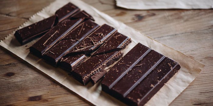 A bar of dark chocolate broken into pieces
