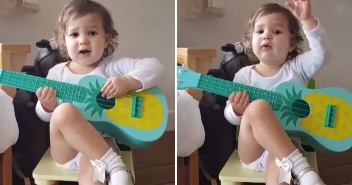 toddler playing fake guitar.jpg?resize=412,275 - Toddler Acts Like A Rockstar While Playing A Toy Guitar