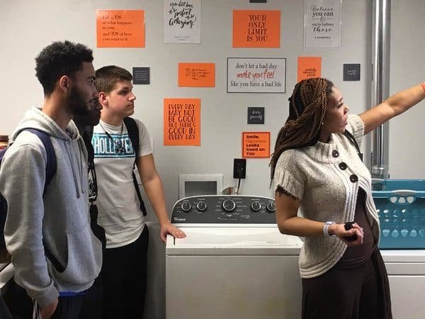 Kaimoku Harris, who oversees Fern Creek High School’s “Laundry and Loot” room, showing students around the new facilities.