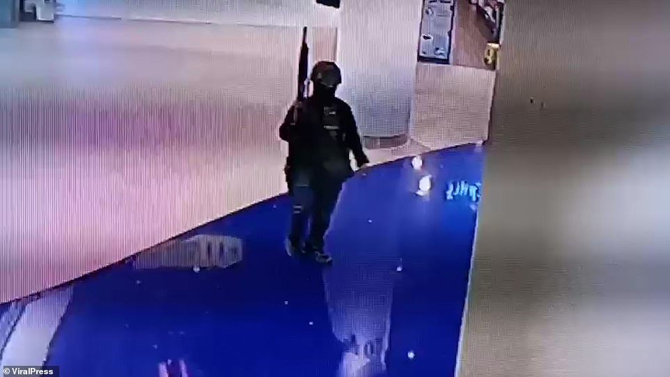 Chilling CCTV show a gunman walking through a mall after killing at least 12 people the taking hostages in Thailand tonight