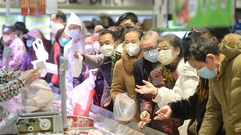 People in Wuhan are only allowed out of their homes for certain reasons, including stocking up on food [China Daily via Reuters]