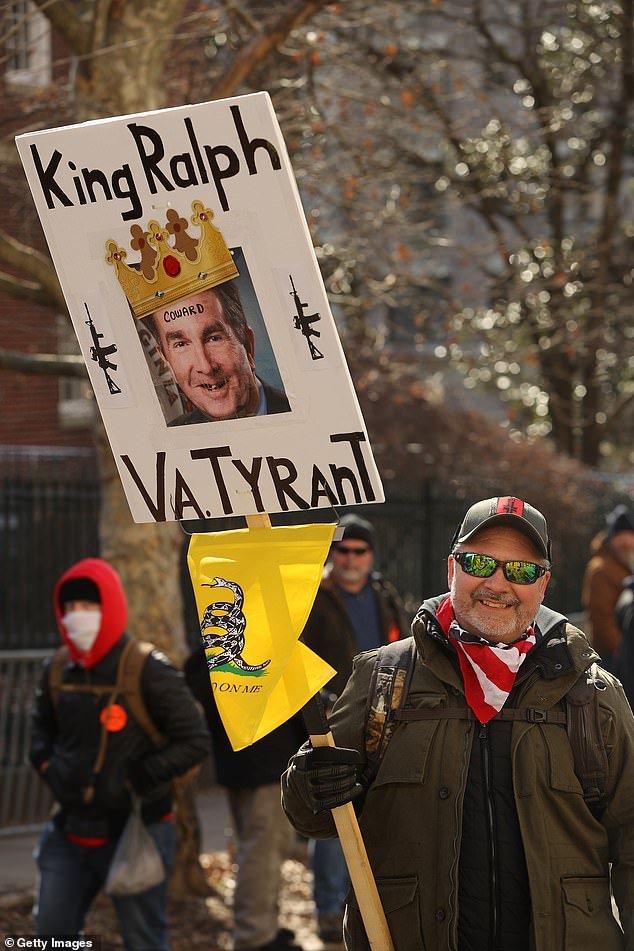 A protester holds a sign at the January 20 rally calling Virginia