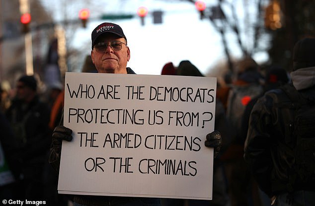 Protester holds a sign at a January 20 rally organized by the Virginia Citizens Defense League