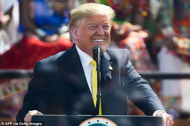 Donald Trump smiles while addressing 