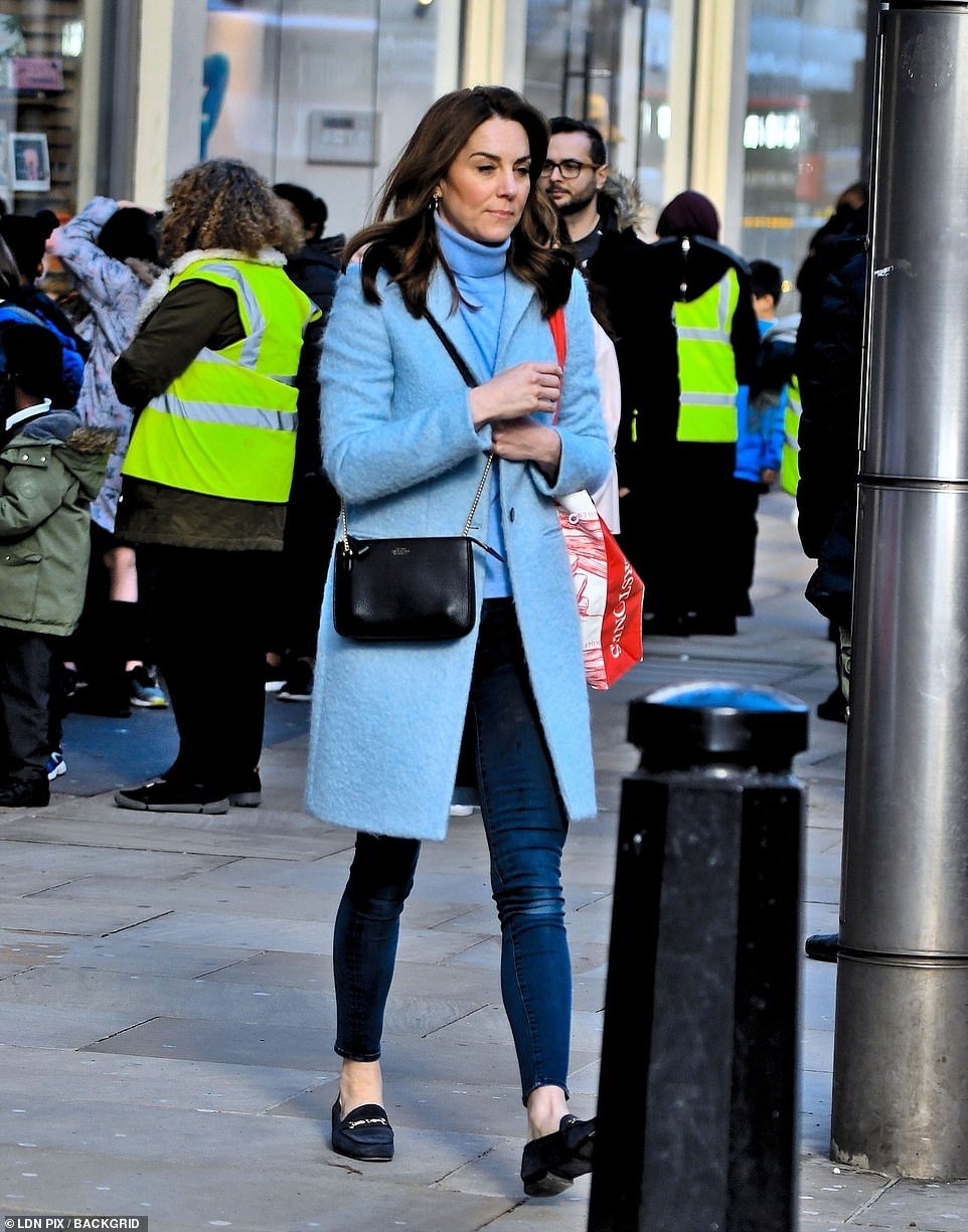 She opted for a matching blue polo neck jumper and overcoat, which she teamed with a pair of dark denim jeans, loafers and a black bag on a gold chain