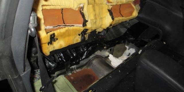 A canine team alerted officers to the secret compartment beneath the seat cushions.