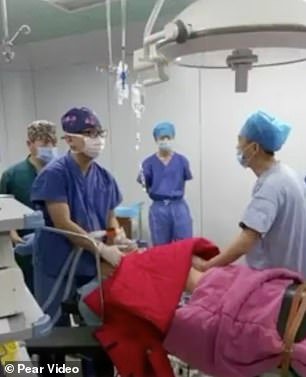 The picture shows Dr Dong performing a surgery with his colleagues
