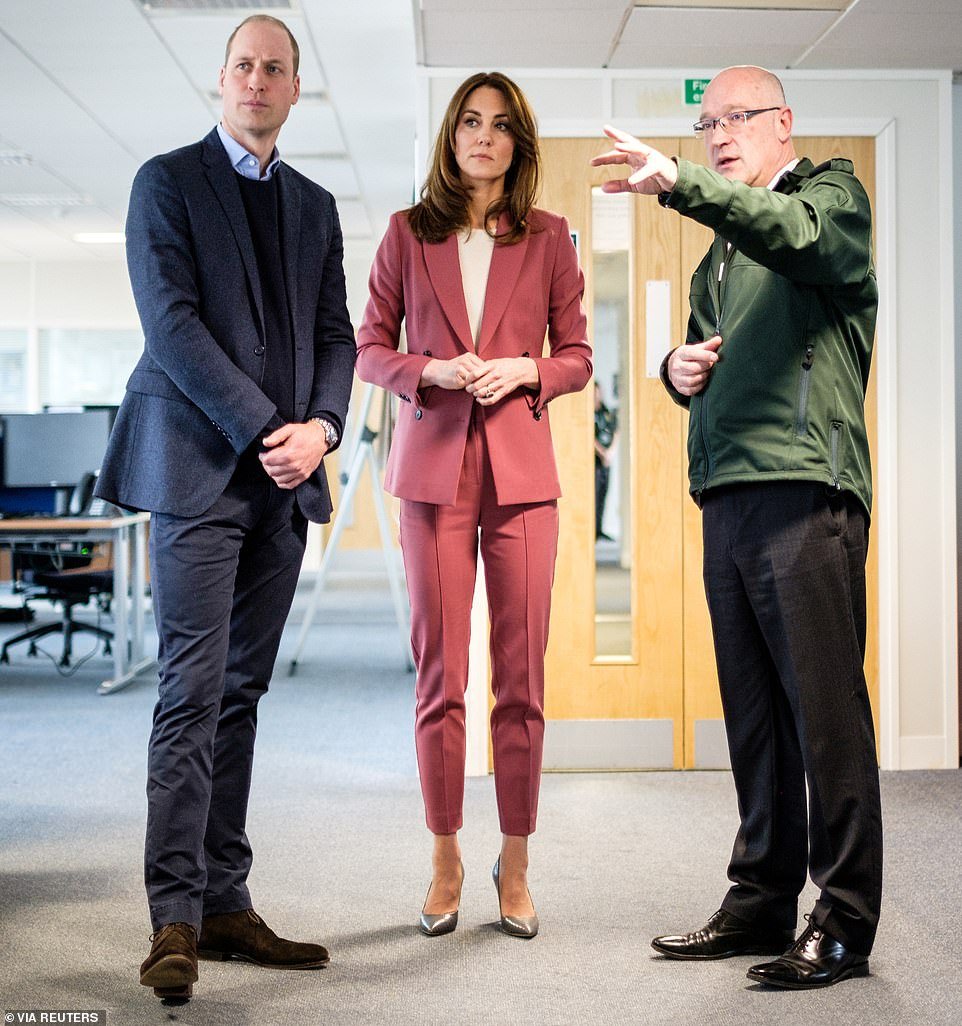 Prince William and Catherine, Duchess of Cambridge, are pictured talking with Chief Executive of the London Ambulance Service, Garrett Emmerson during a visit to the London Ambulance Service 111 control room in Croydon on March 19
