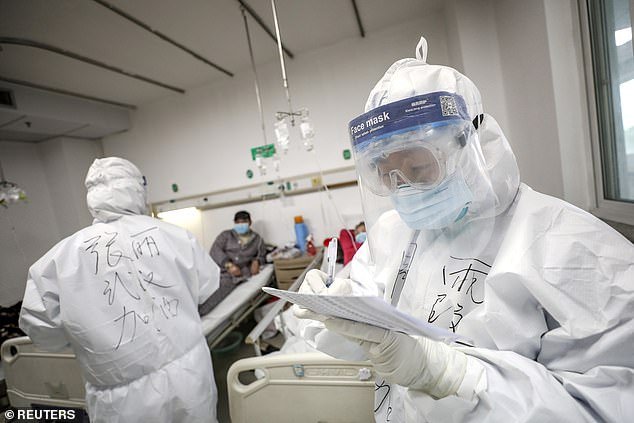 At least 46,000 people have died of COVID-19 and more than 917,000 have been infected worldwide. A medical worker is pictured checking a patient