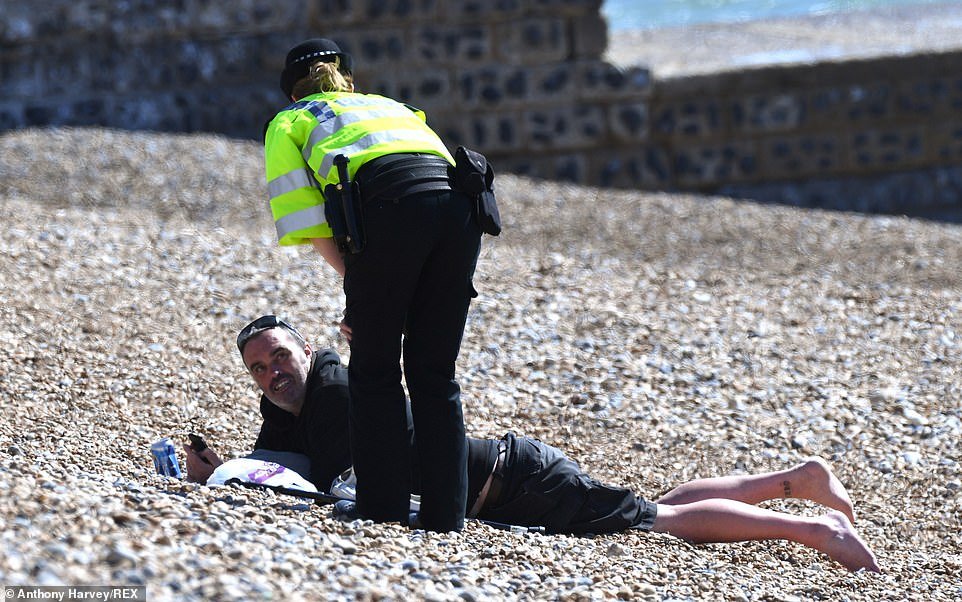 Officers went onto Brighton beach yesterday to ask sunbathers to go back home and self-isolate