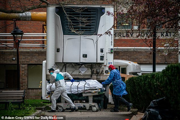 Bodies are moved to and from refrigerated morgue trailers at Kingsbrook Jewish Medical Center, Brooklyn