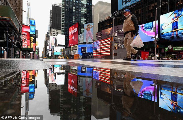 Kashkari, who oversaw the Troubled Asset Relief Program that the U.S. implemented in the wake of the 2008 financial crisis, told Americans to brace themselves for 18 months of shutdowns (Pictured: A man crosses the street at a nearly empty Time Square on April 9)