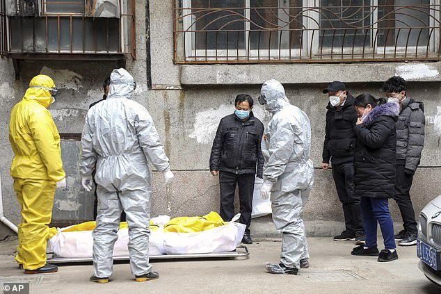 Medical staff in Wuhan are seen removing the body of a person suspected to have the coronavirus