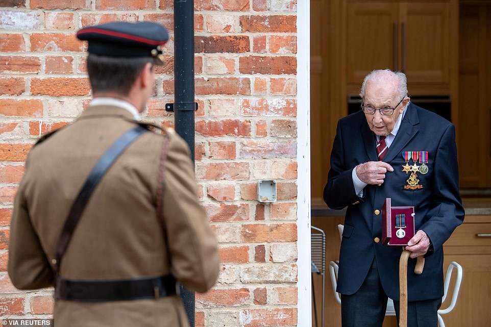 Newly-appointed Colonel Tom holds his Yorkshire Regiment Medal next to Lieutenant Colonel Thomas Miller at his home in Bedfordshire