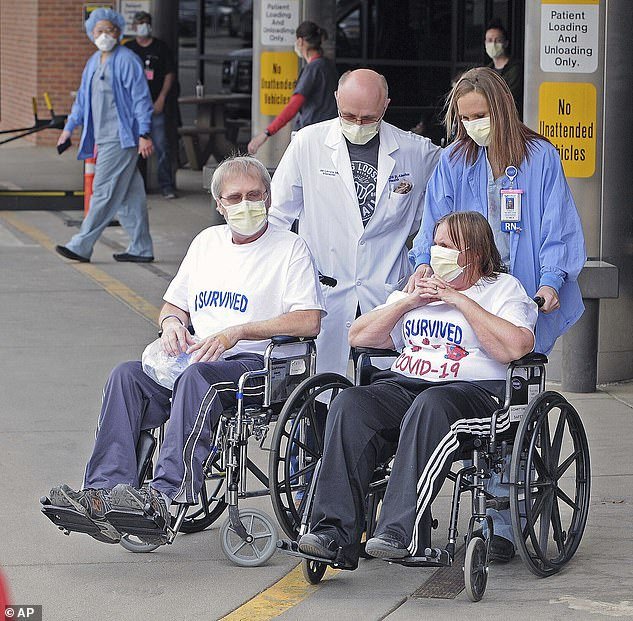 Researchers believe the number of recoveries is likely higher due to the number of people with antibodies who never tested positive for the virus. Pictured: Dr Jan Levora (left) and nurse Kristen Renner (right) wait outside CHI-St Alexius Health in Bismarck, North Dakota, with Gery (left) and Betty DeGreef of Mandan, both of whom recovered from the virus