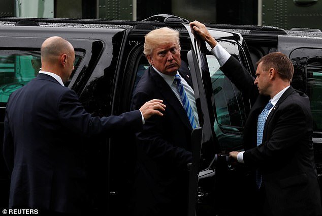 Secret Service agents hold the door for President Trump (center) in May 2018. Eleven members of the Secret Service have tested positive for COVID-19, according to an internet news report