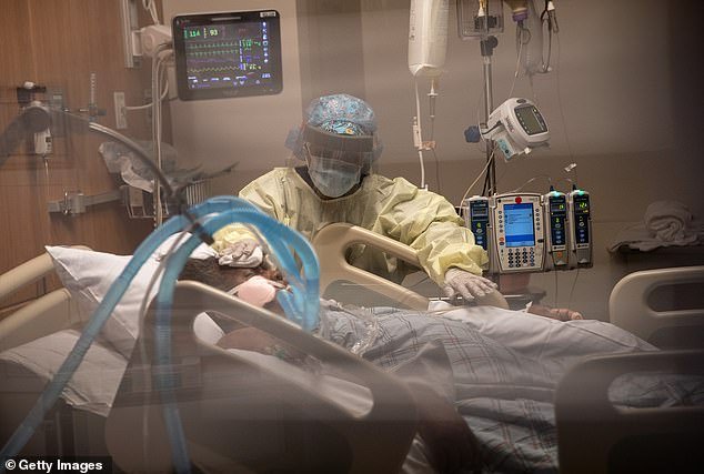 Pictured: A nurse cleans a patient with COVID-19 on a ventilator at a Stamford Hospital Intensive Care Unit on in Stamford, Connecticut