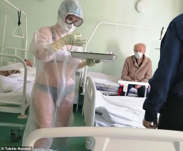 A nurse on an all-male coronvirus ward in Russia has been disciplined after a picture of her wearing only underwear underneath a transparent PPE gown went viral